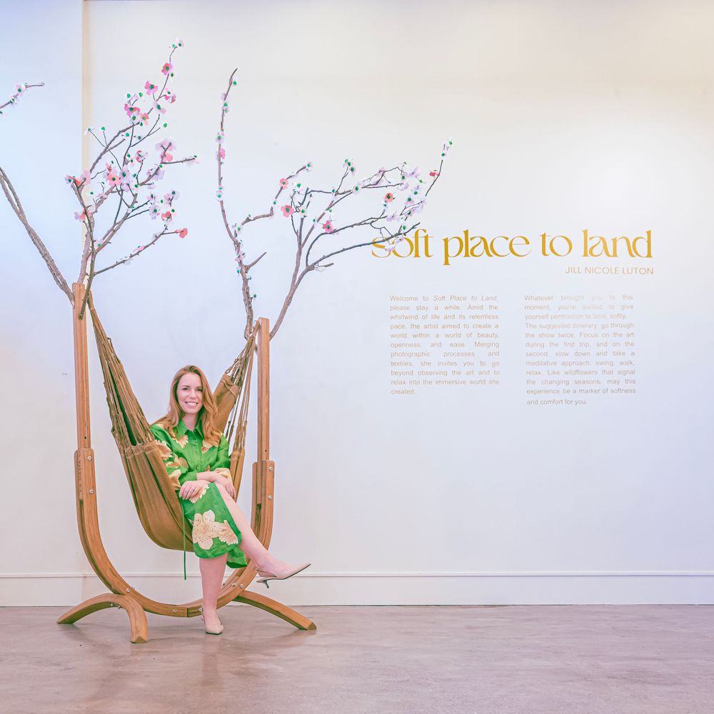 A figure in a green leotard performs a graceful dance sequence against a white wall with text.