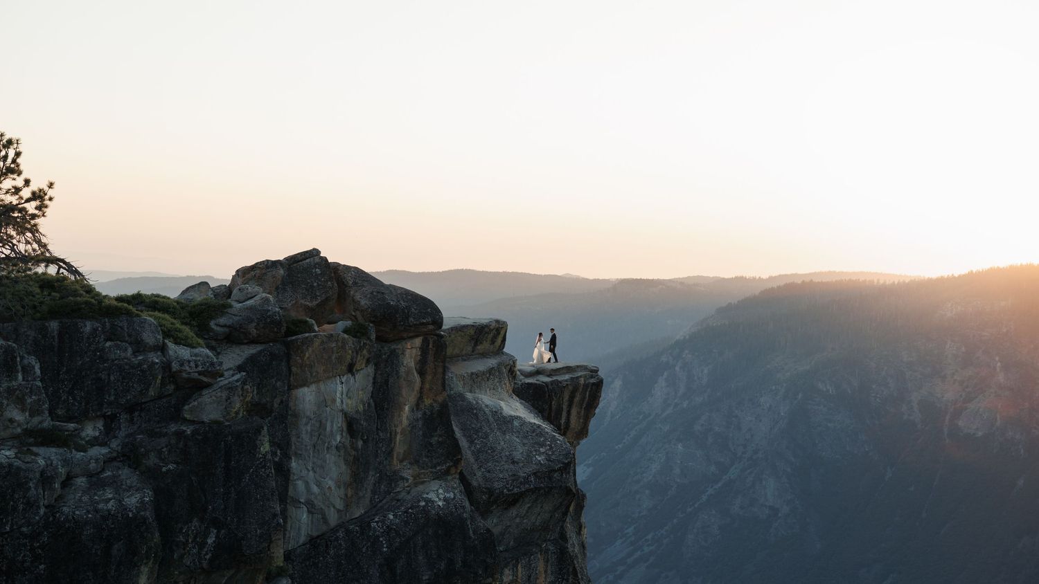 Panoramic mountain landscape view at sunset with silhouettes against the sky.