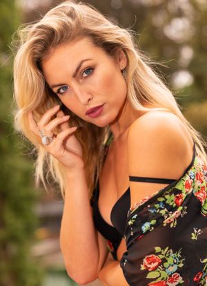 a photo by a professional photographer of a professional model during a model or fashion photo session in lingerie