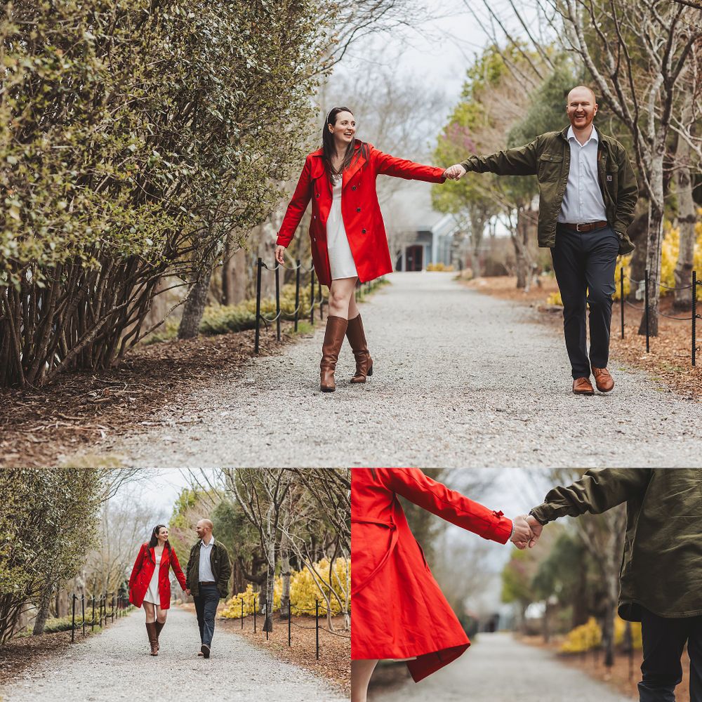 Couple walks and dances along tree-lined path during engagement session.