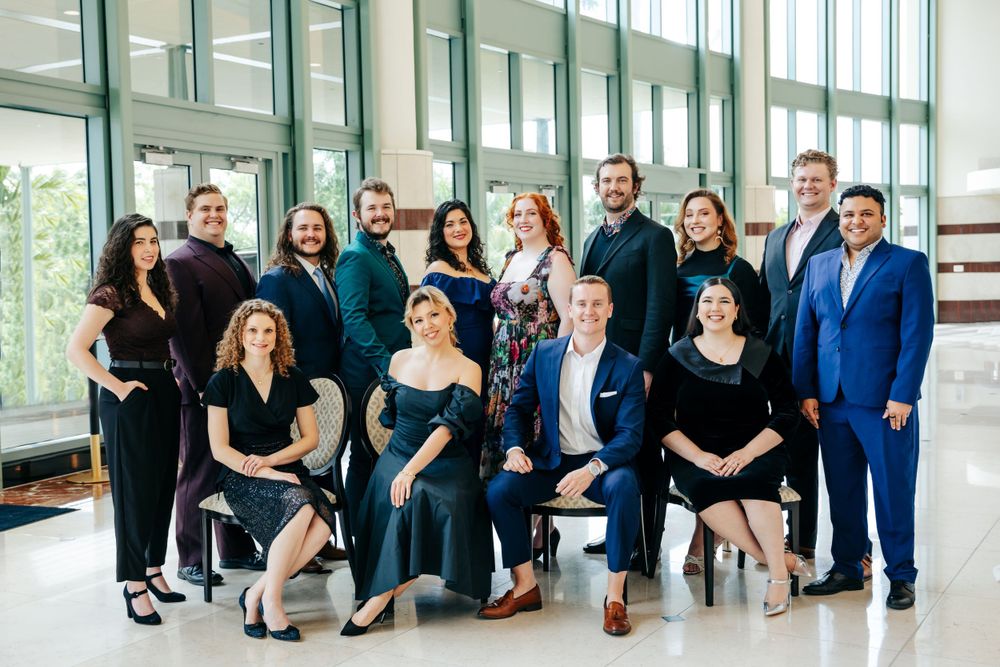 Team members gathered for a professional group photo in a modern office setting.