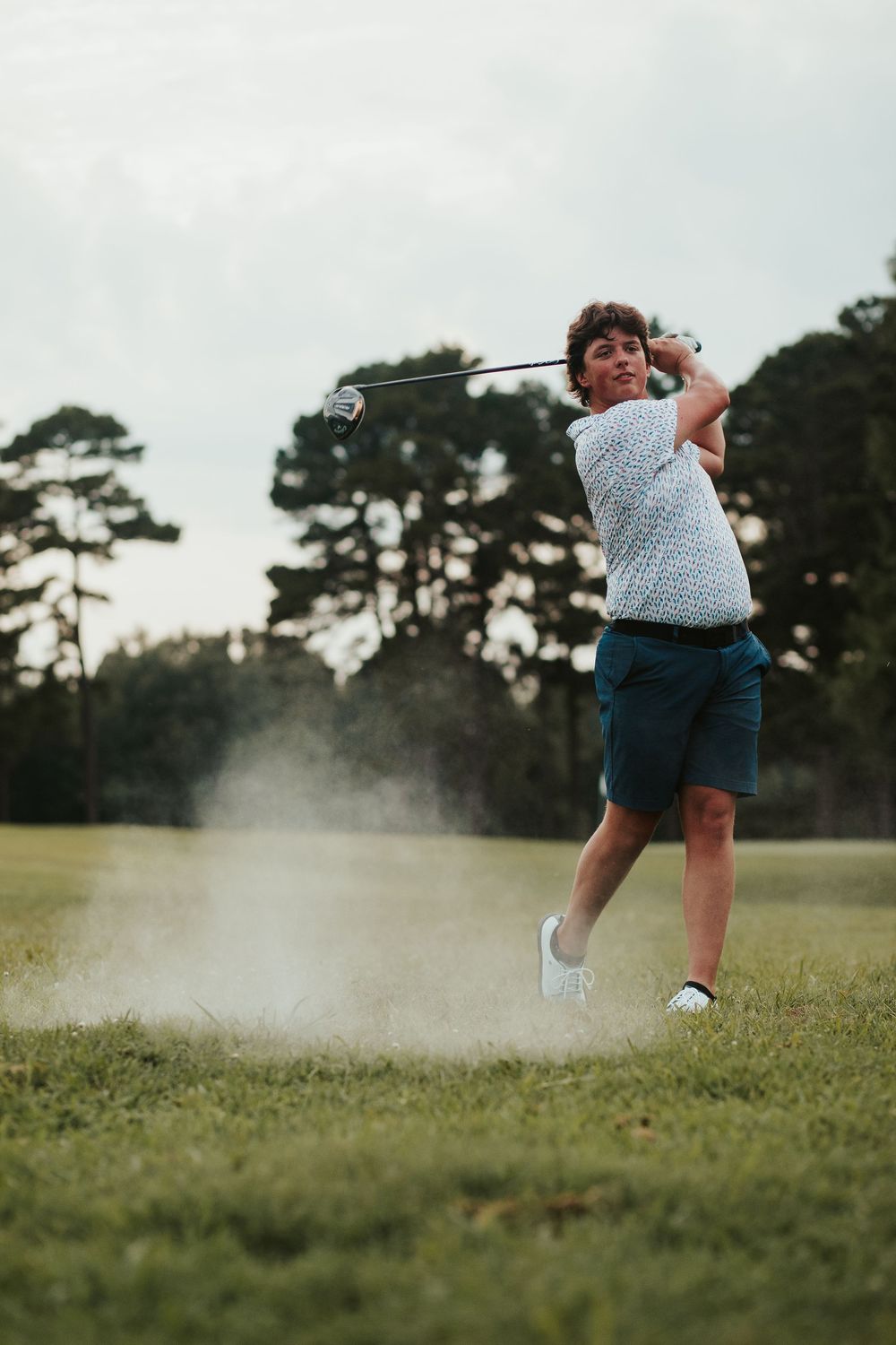 golfing portrait with exploding golf ball