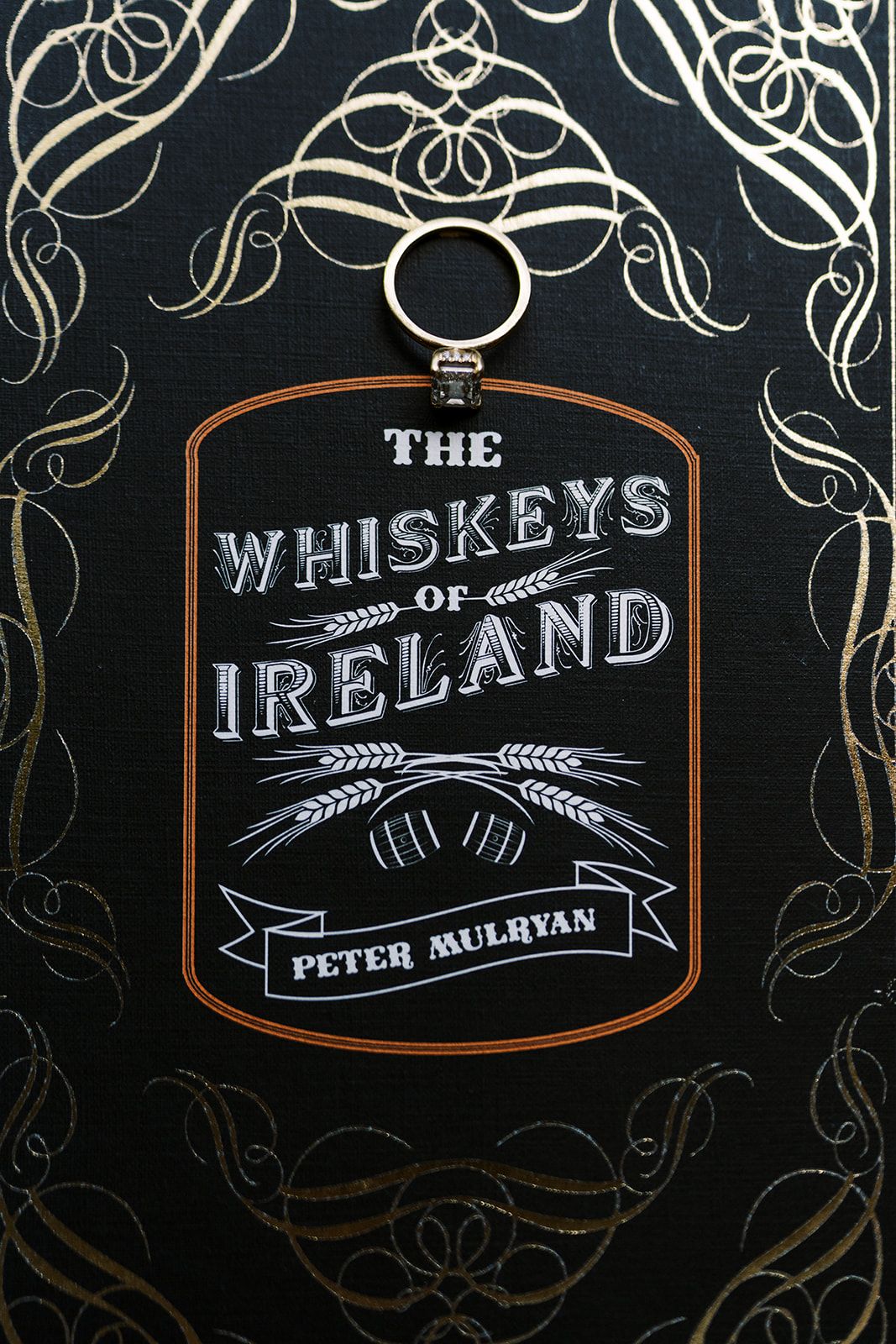 A black book cover featuring decorative typography for The Whiskeys of Ireland.