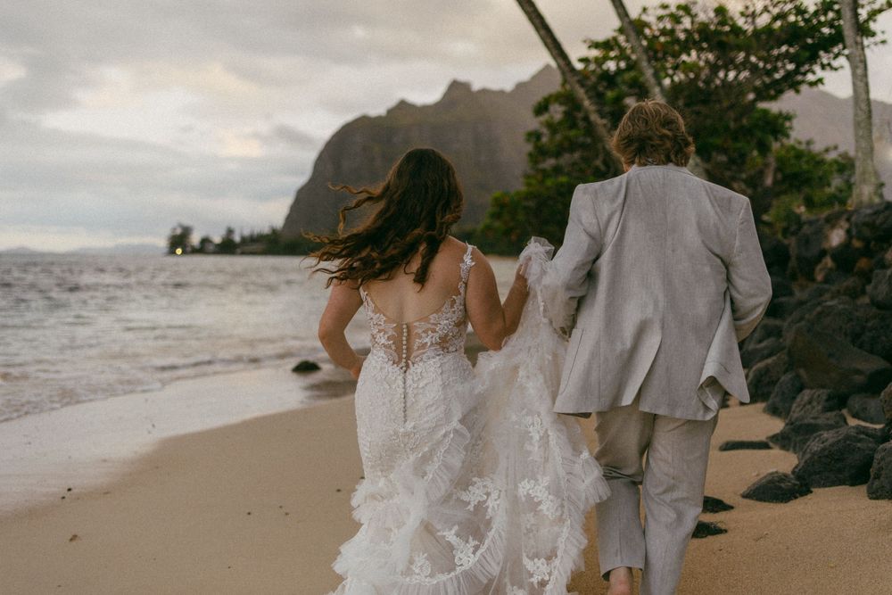 wedding couple running on the beach in Hawaii
