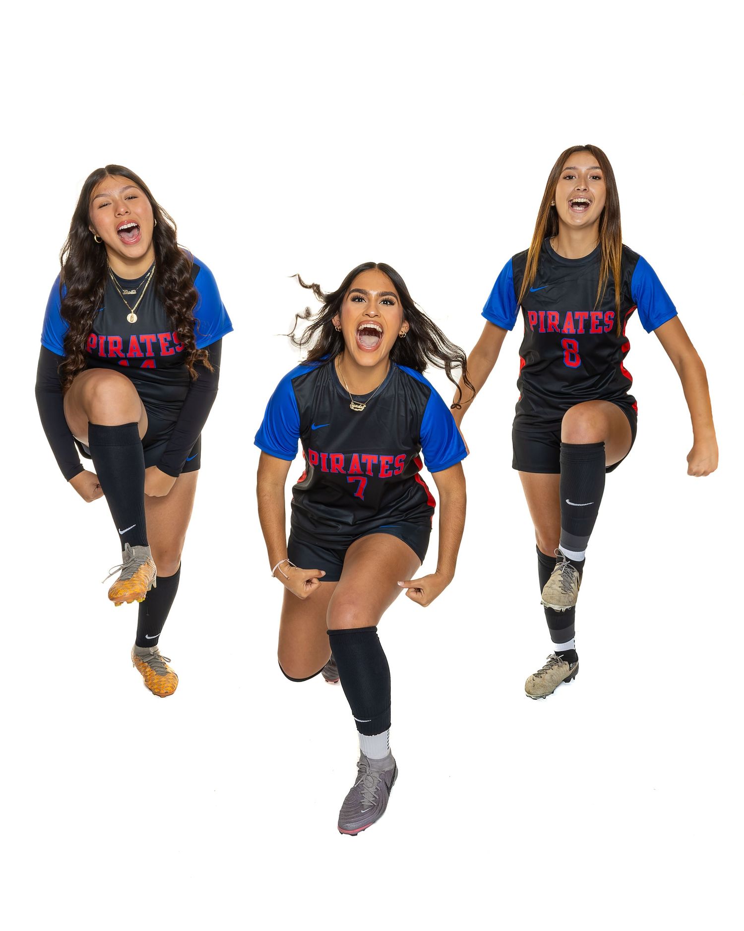 Three athletes in Pirates uniforms jumping and celebrating together.