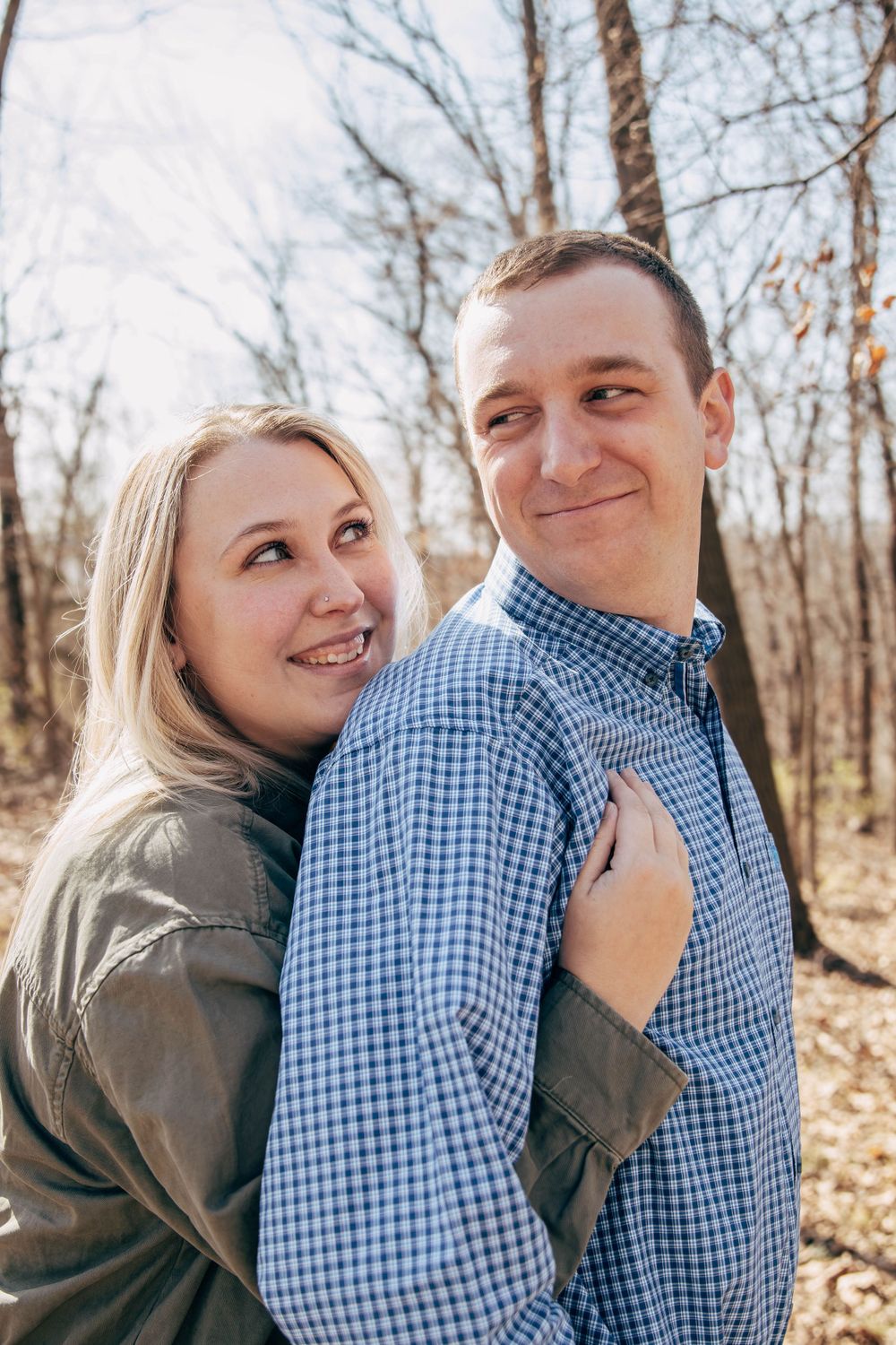 A couple sharing an intimate moment while enjoying nature on a forest trail.