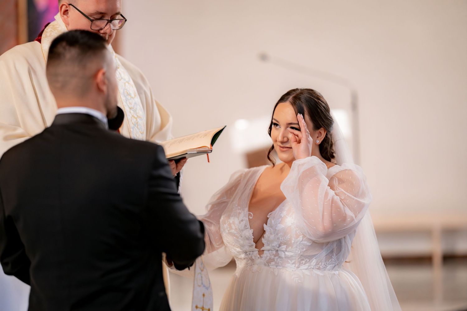 An emotional moment during a wedding ceremony as vows are exchanged.