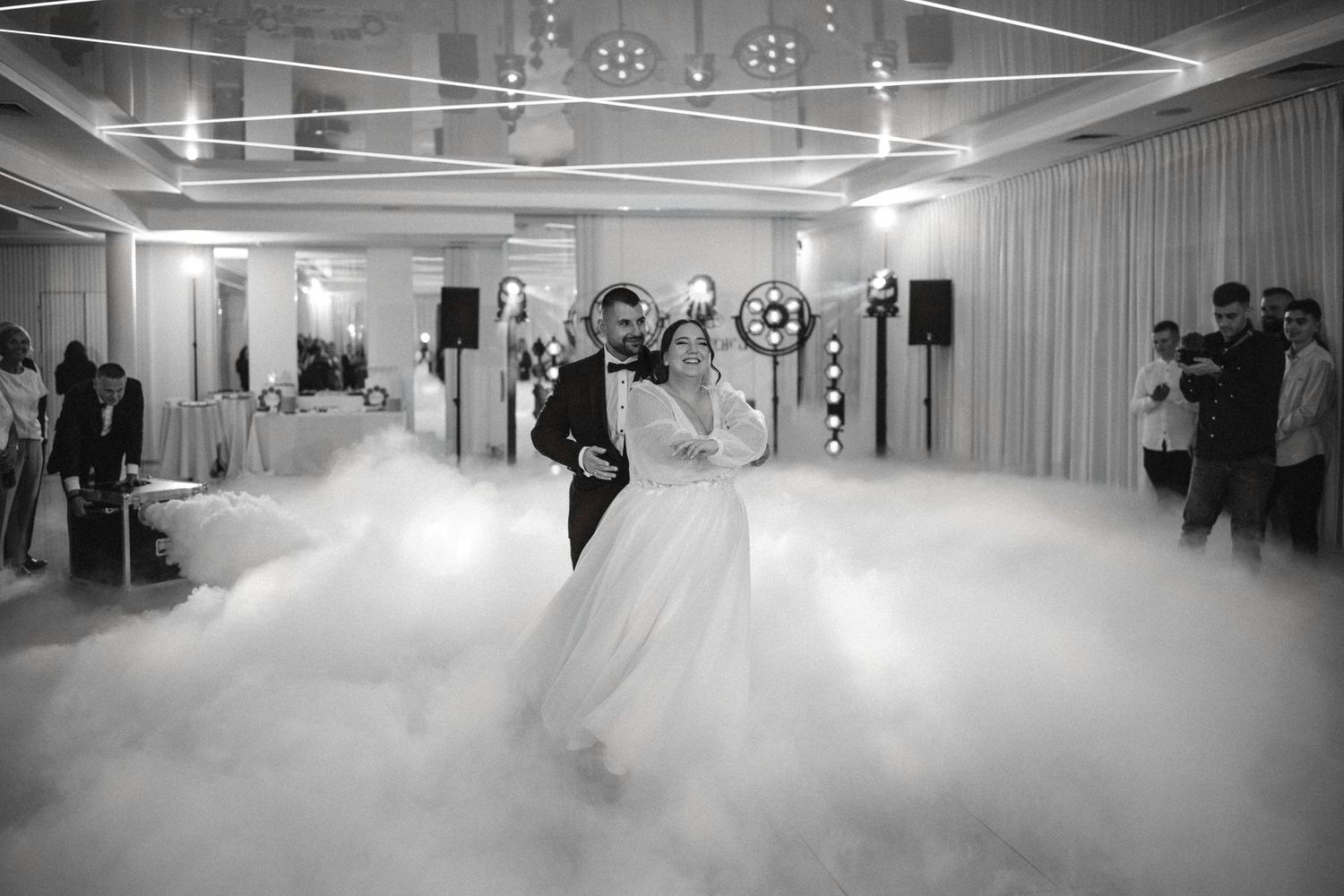 A dreamy black and white wedding dance scene with fog effects on the dance floor.