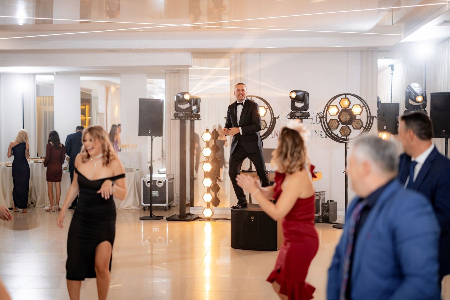 Wedding reception dance party with vintage-style lighting and decorative elements.