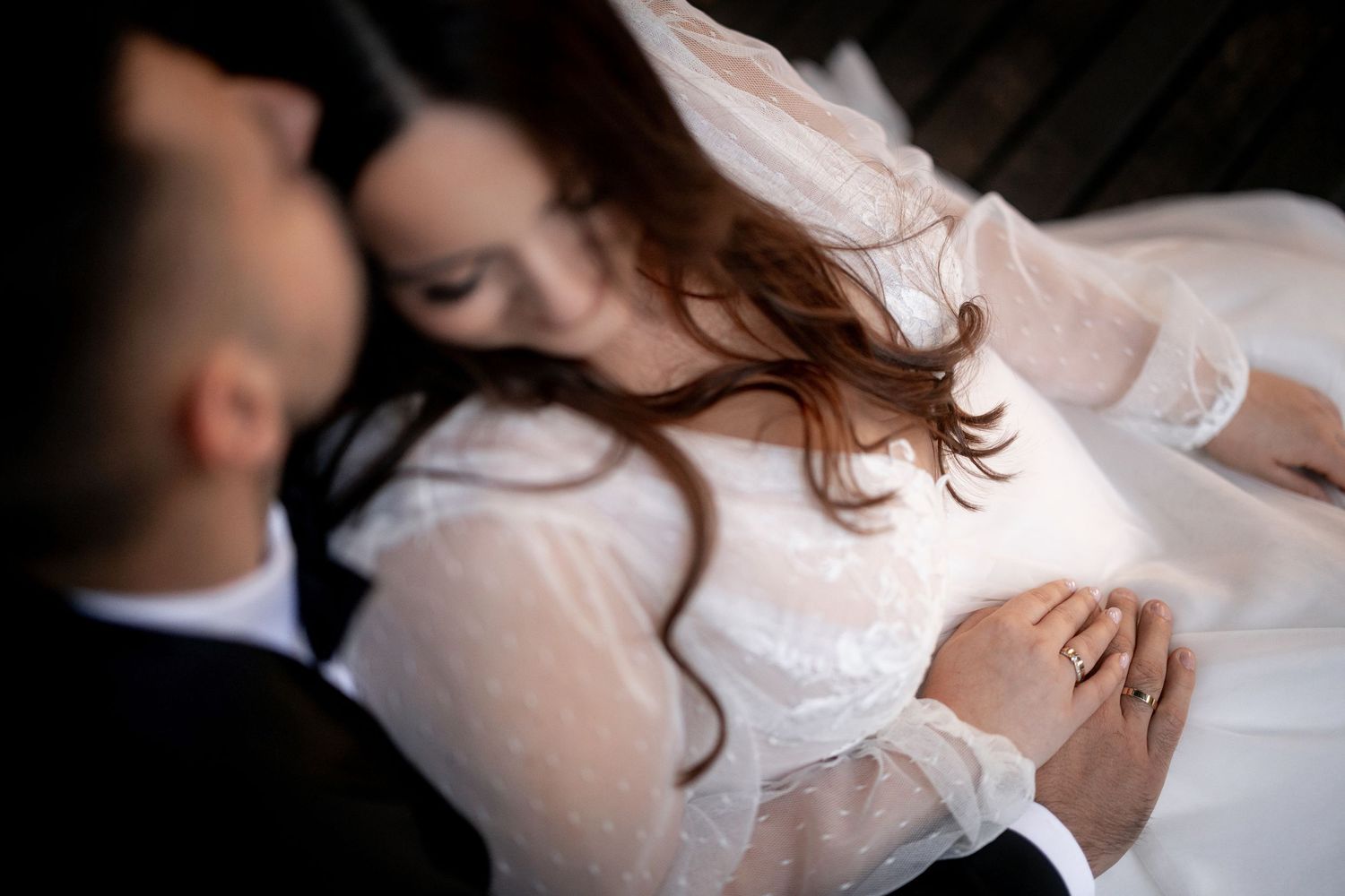 An intimate wedding portrait capturing a tender moment between newlyweds in soft natural light.