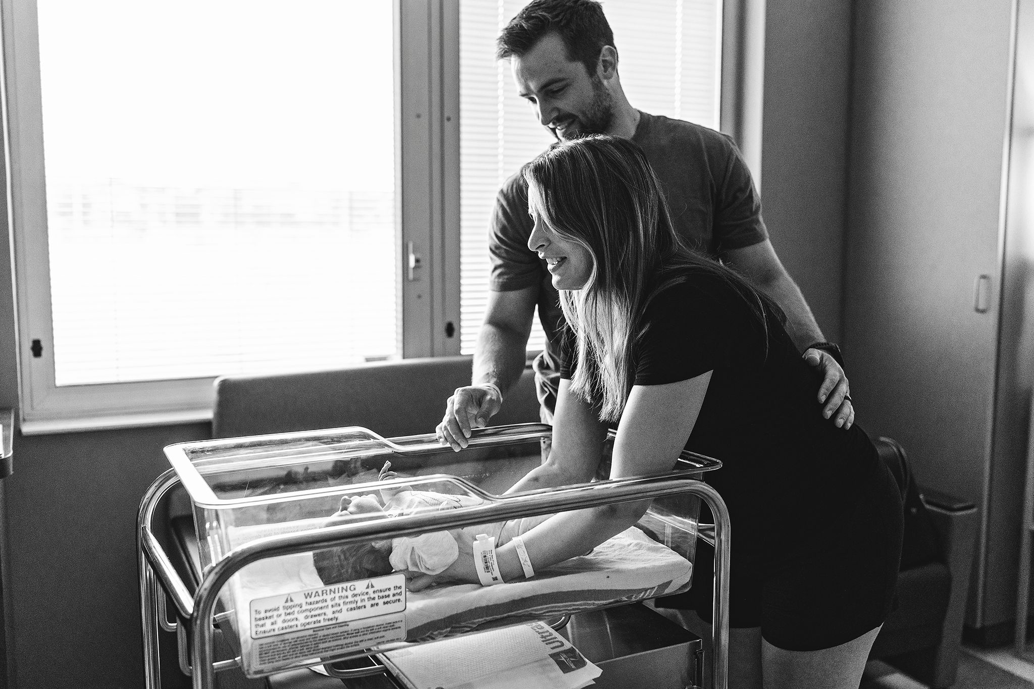 mom picking up her newborn at their fresh 48 session