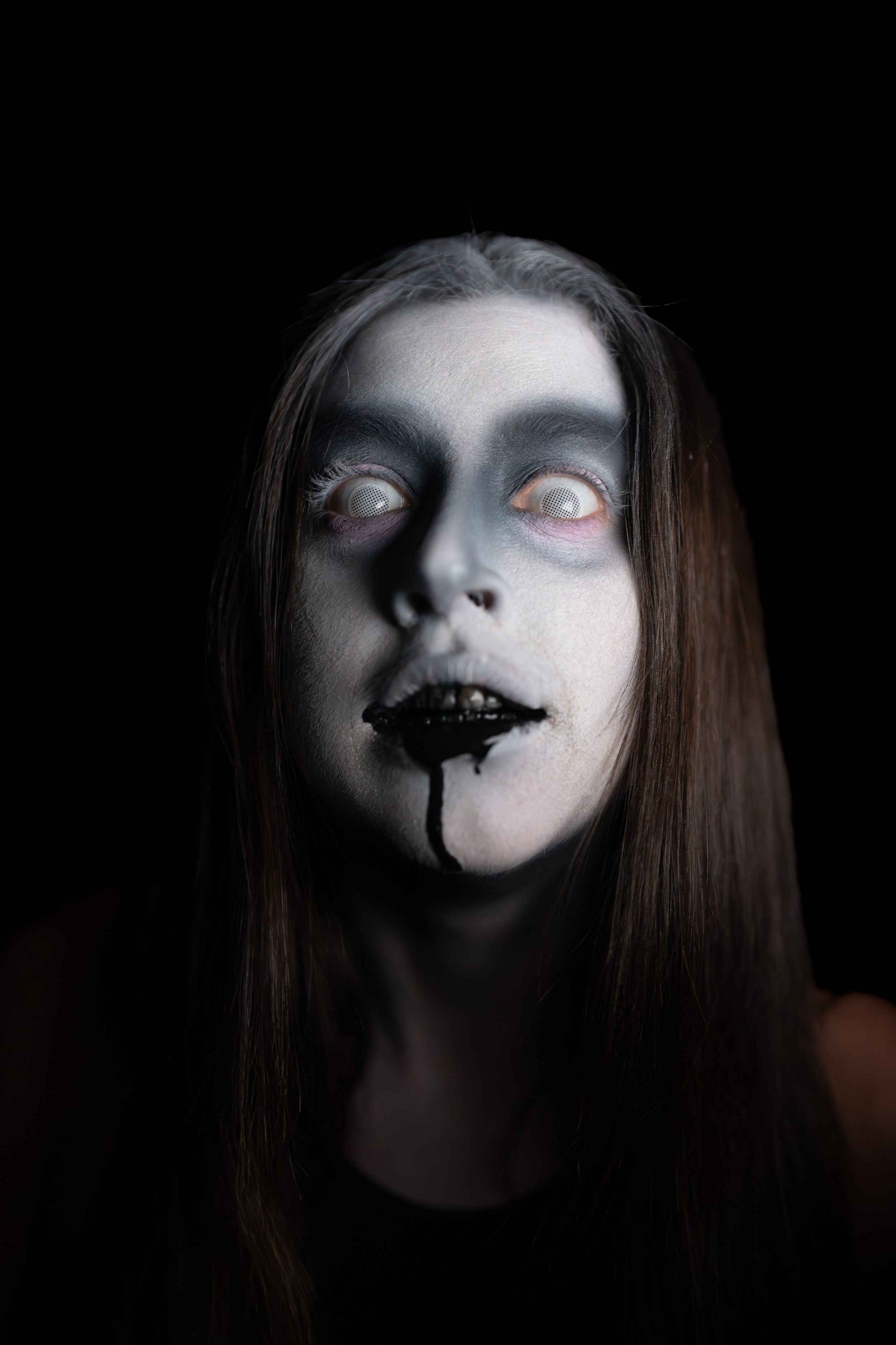 Creepy ghost with black liquid coming out of its mouth.