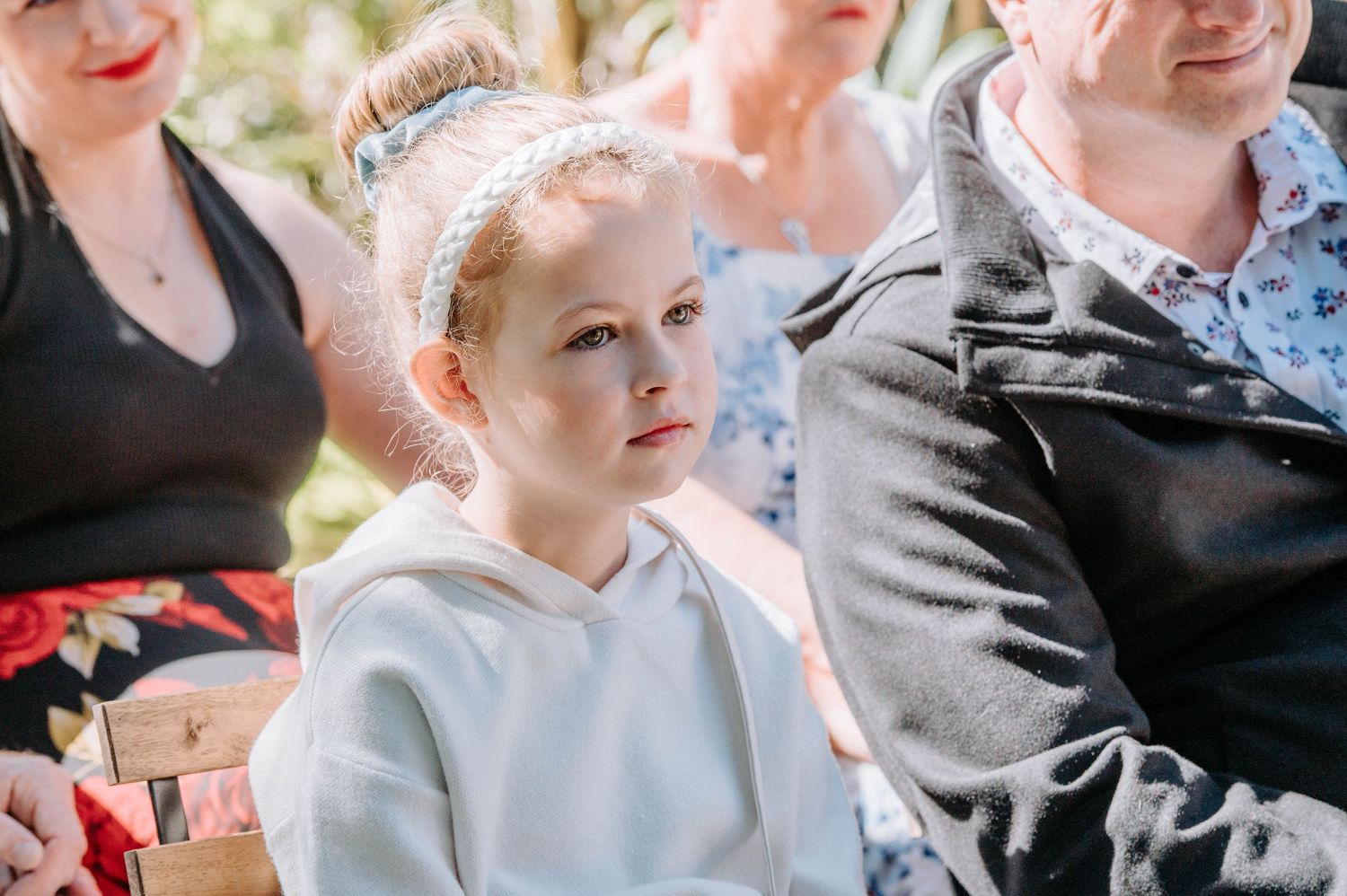 A guest in light clothing at an outdoor celebration.