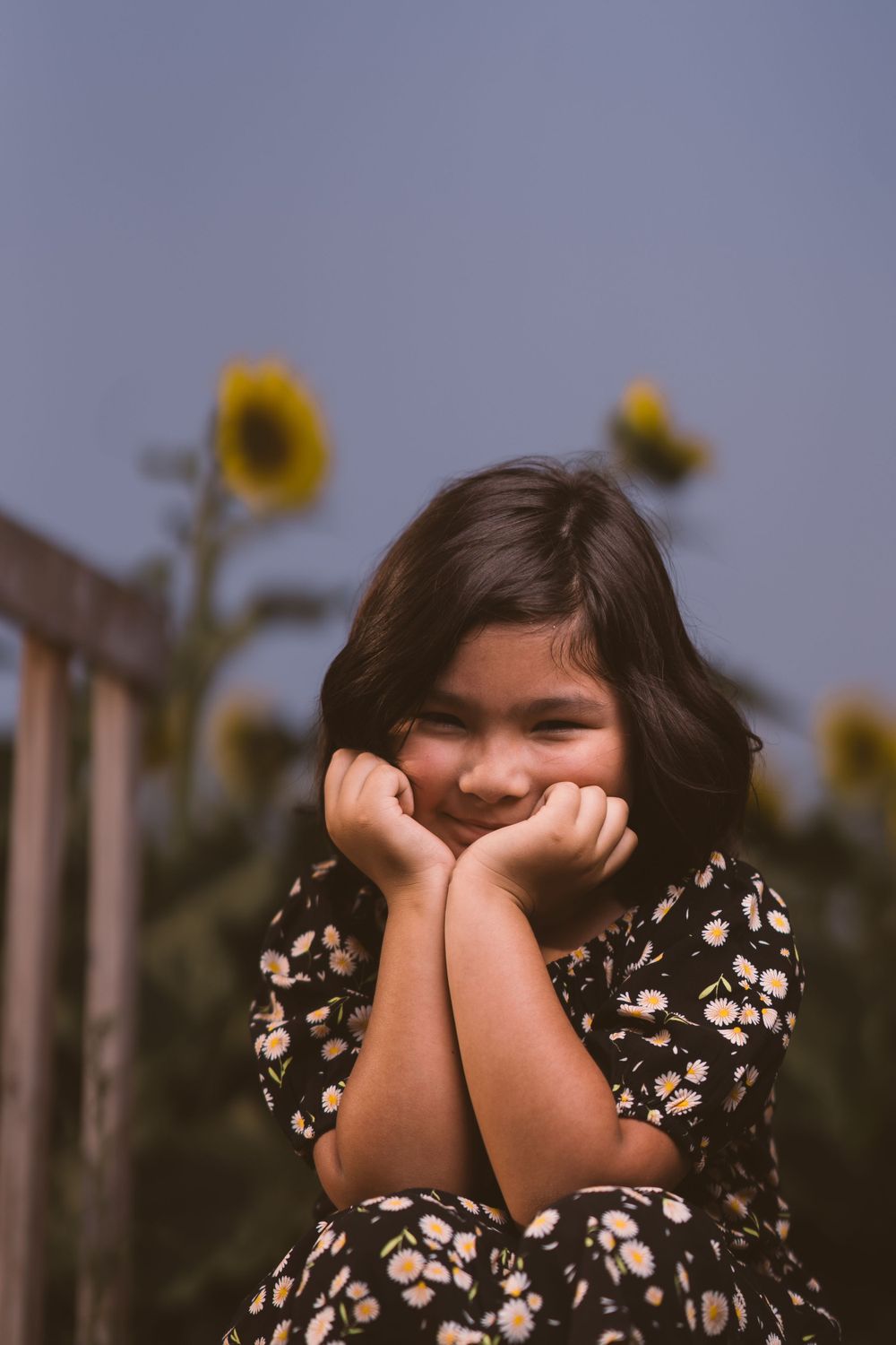 Candid sequence showing playful poses and expressions with sunflowers in background.