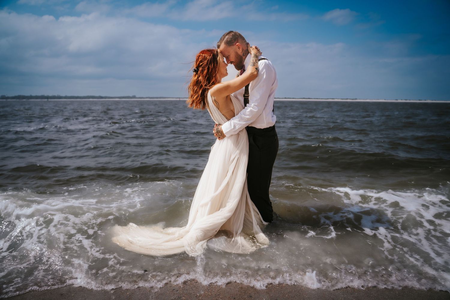 Elopement Bride and Groom are wisked away on the beach of Fort Clinch