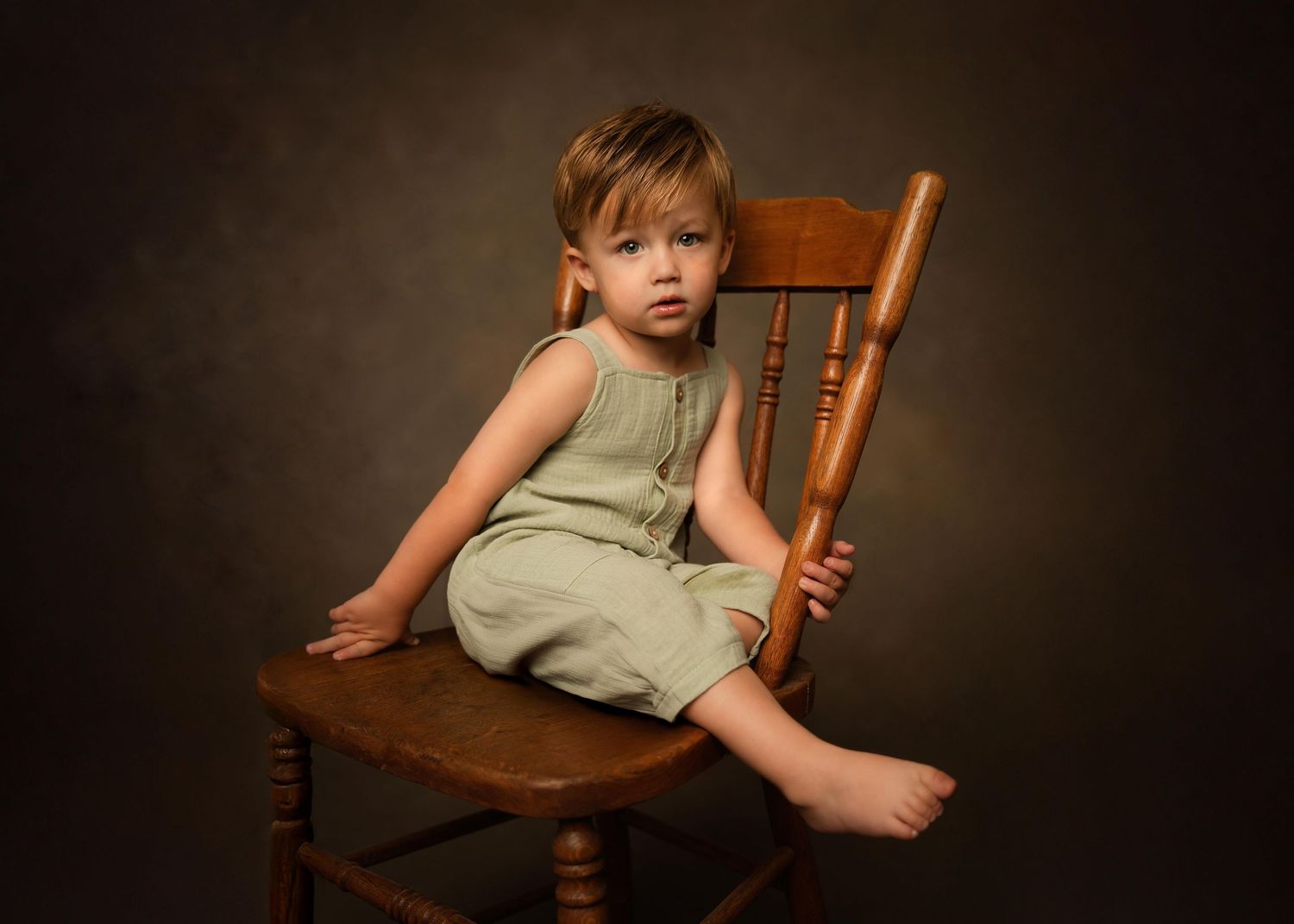 Fine Art Portrait of little boy sitting in an old chair