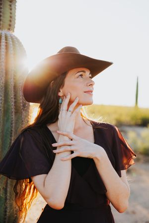 Dramatic desert portrait with expressive poses and golden sunlight filtering through cacti.