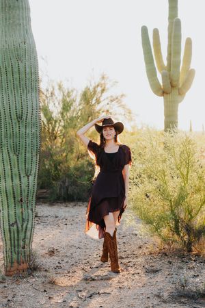 Western-themed portrait against backdrop of iconic Arizona desert landscape.
