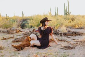 Desert photography session with saguaro cacti and natural desert terrain at sunset.