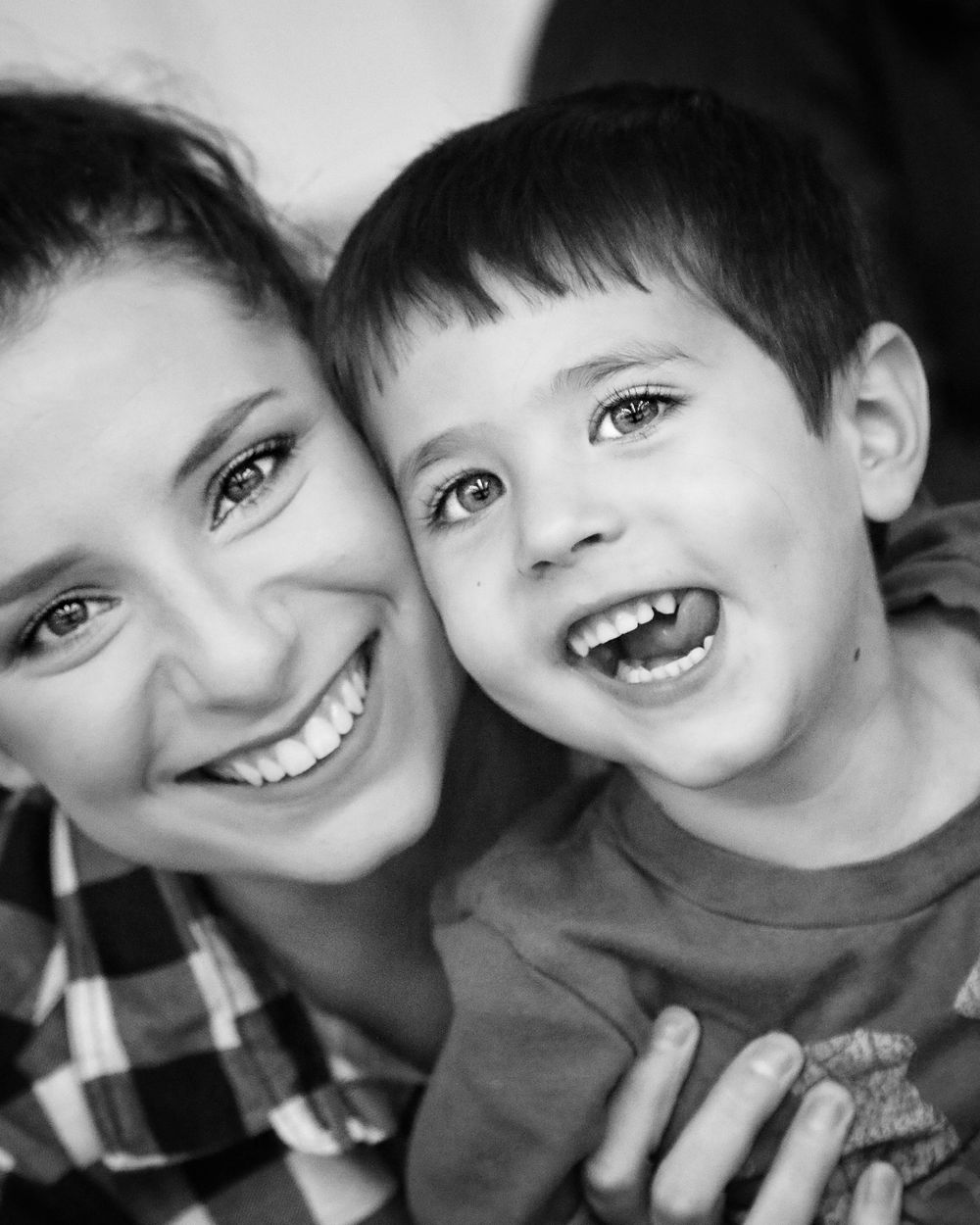 Black and white portrait showing joyful expressions in a casual setting.