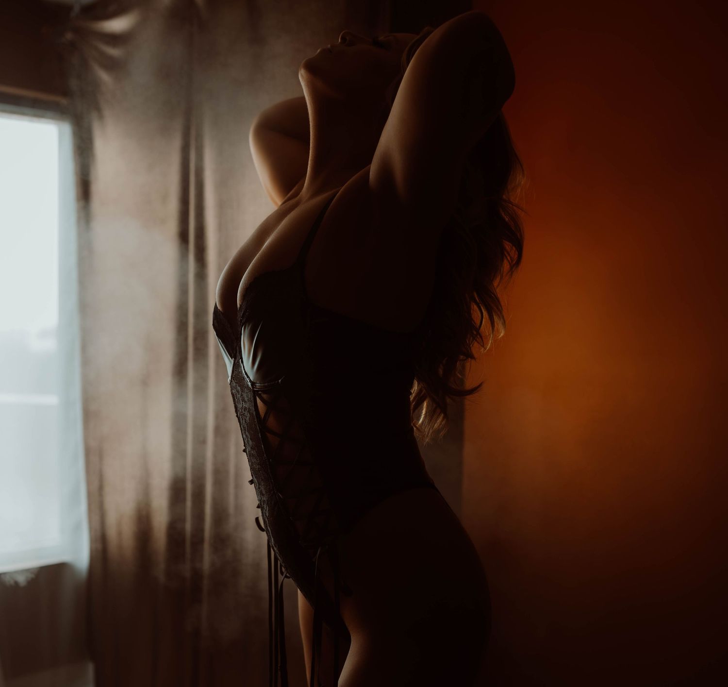 Silhouette of a figure in artistic moody lighting creating a mysterious and contemplative atmosphere.