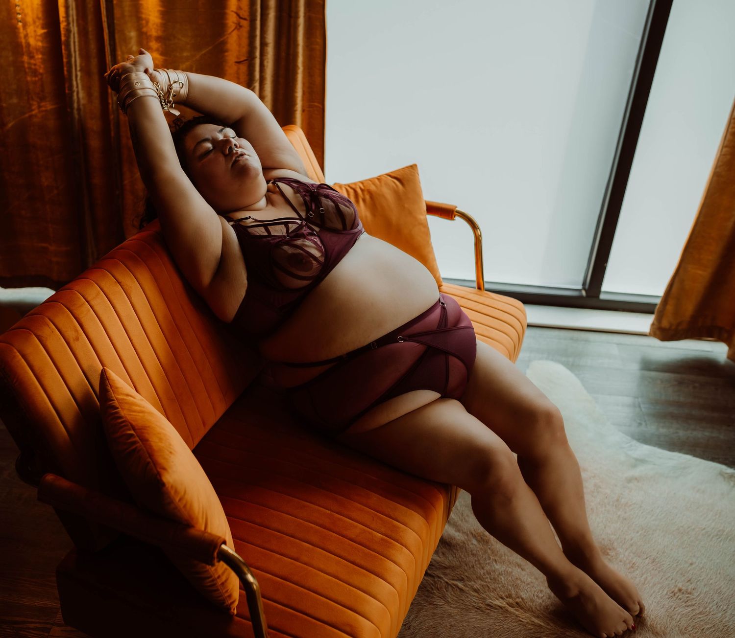 Curvy woman embracing her beauty in the skin she is in with boudoir photography.