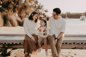 A collection of warm-toned romantic engagement photos showing couples sitting and embracing outdoors at sunset.