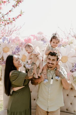 Four joyful photos against cherry blossoms and vintage backdrops showing tender moments and laughter.