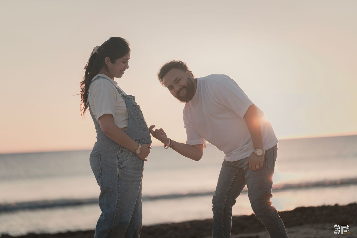 Expecting mother captured in a natural, candid moment during her maternity photoshoot, radiating joy and anticipation.