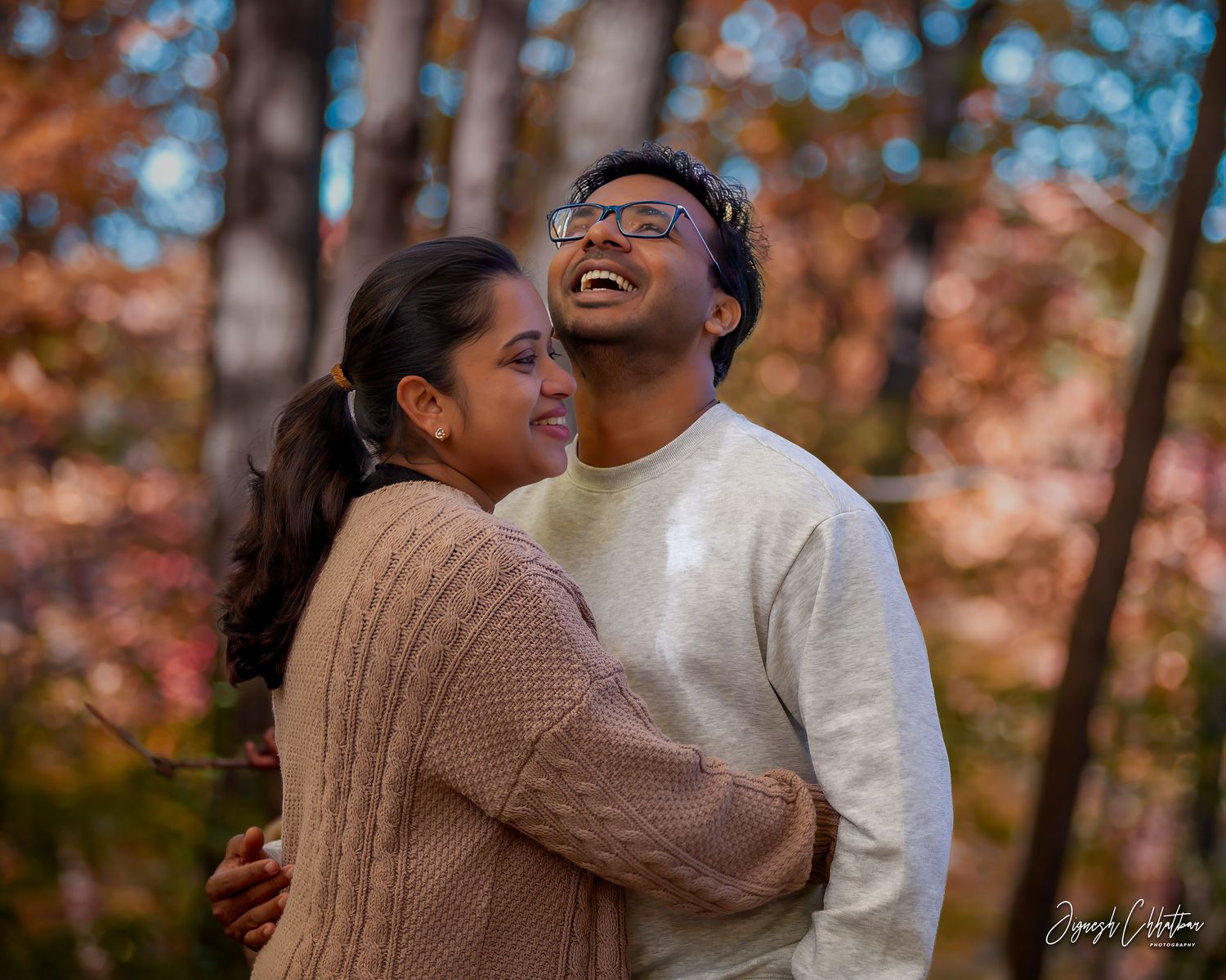 Outdoor candid photo of a couple enjoying a moment together, surrounded by nature, capturing their love and connection.