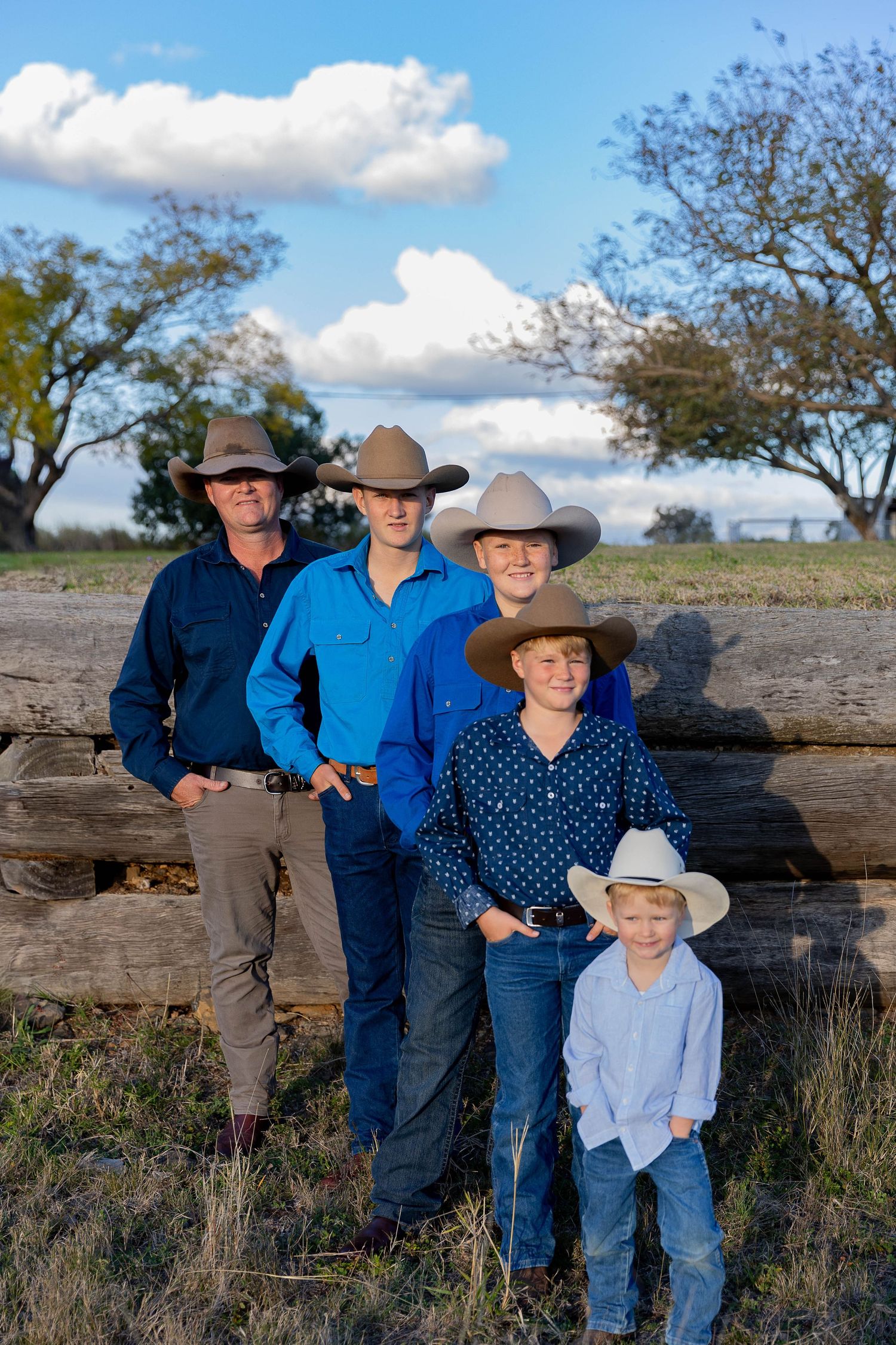 Father and sons standing in front of loading ramp at father's day mini photo shoot