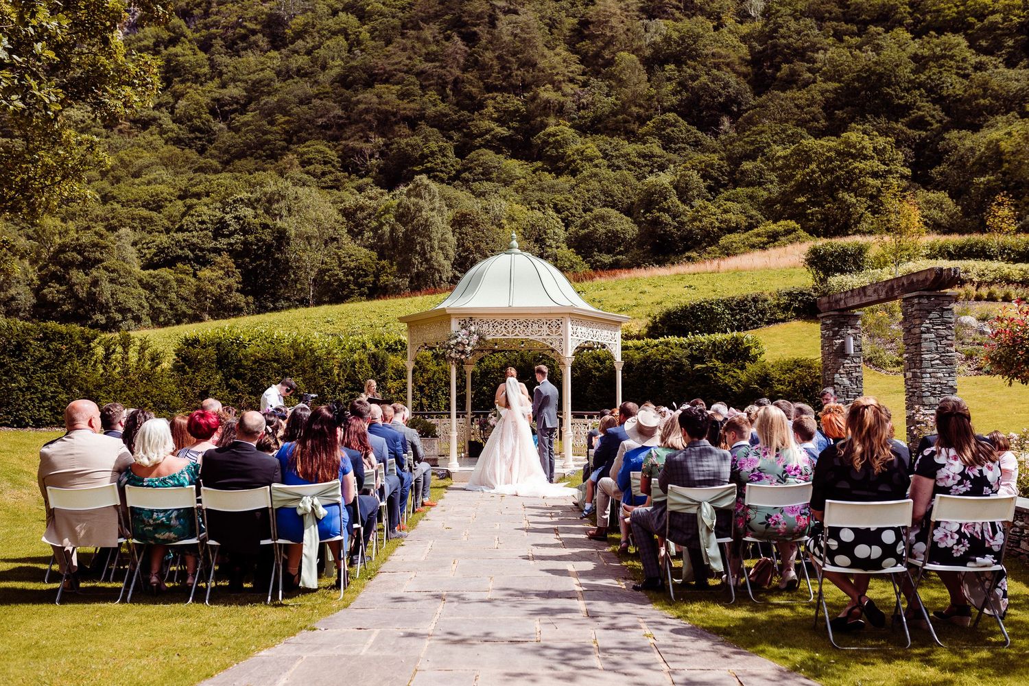 Lodore Falls Hotel wedding venue and grounds - bride and groom get married outside by the pavilion