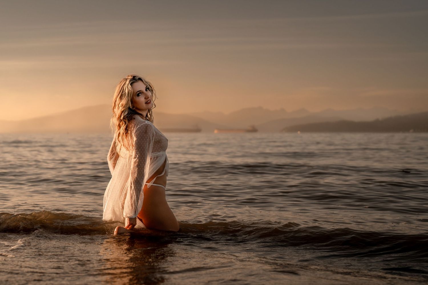Elegant boudoir session Vancouver woman posing in soft natural light, in the light dress in the ocean