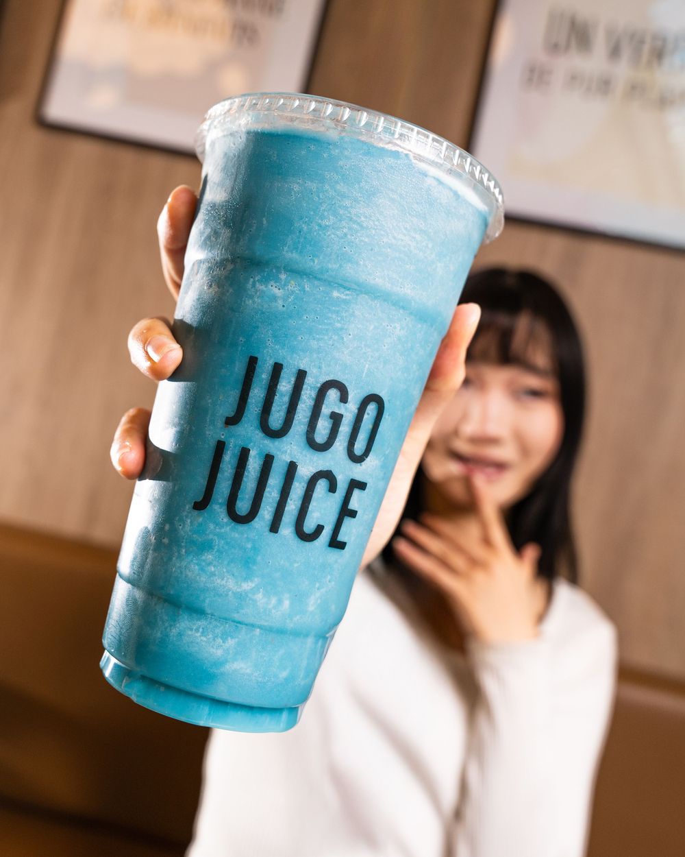 Blue frozen smoothie drinks in clear plastic cups with JUICE branding.