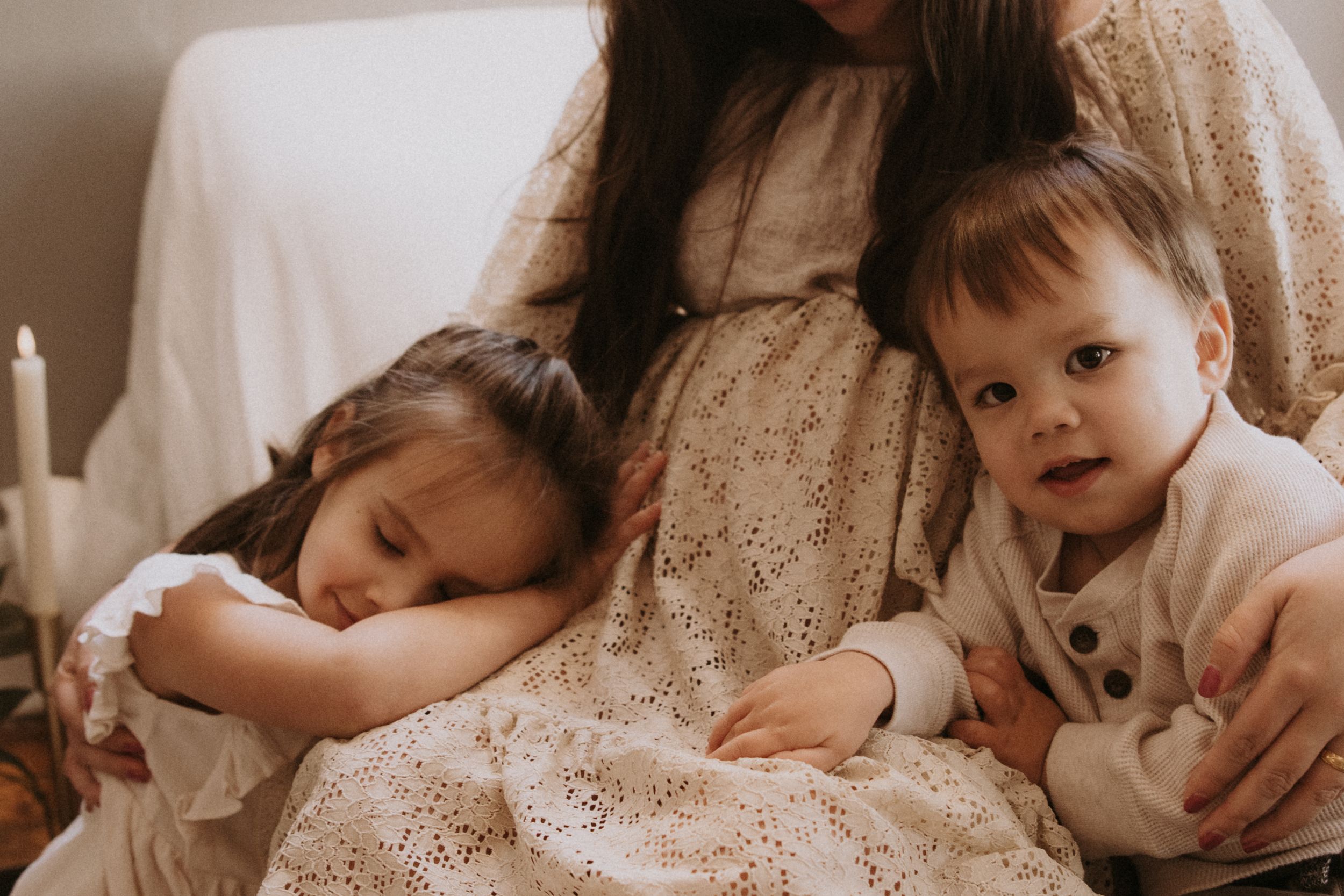 A series of intimate black and white photographs showing tender family moments in soft natural lighting.
