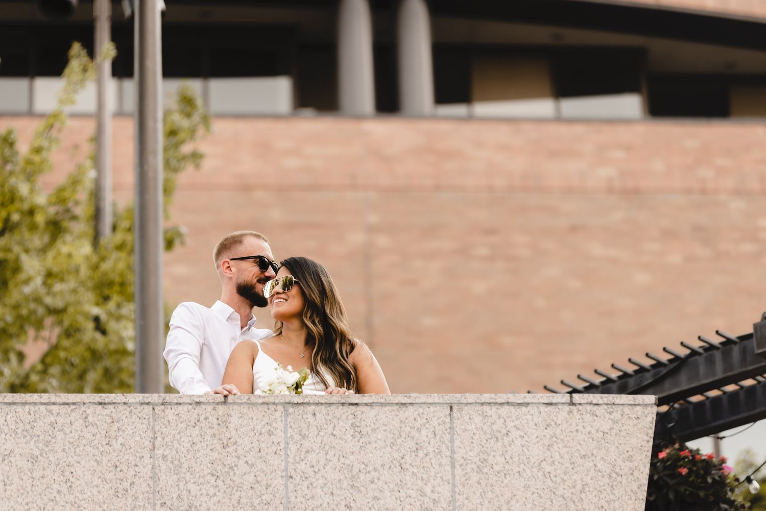 A couple celebrates their wedding day in a joyful moment surrounded by falling confetti and sparklers.