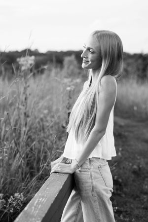 Black and white artistic portraits capturing genuine smiles in a natural setting.