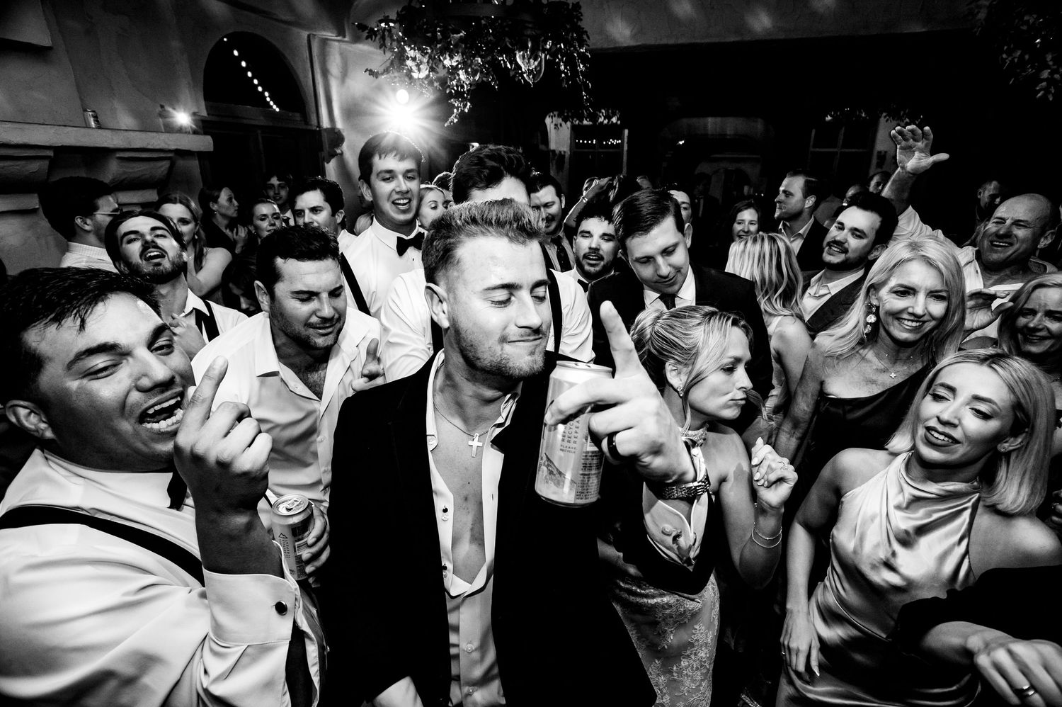 A black and white photo strip showing people dancing and celebrating at wedding reception at Villa Antonia