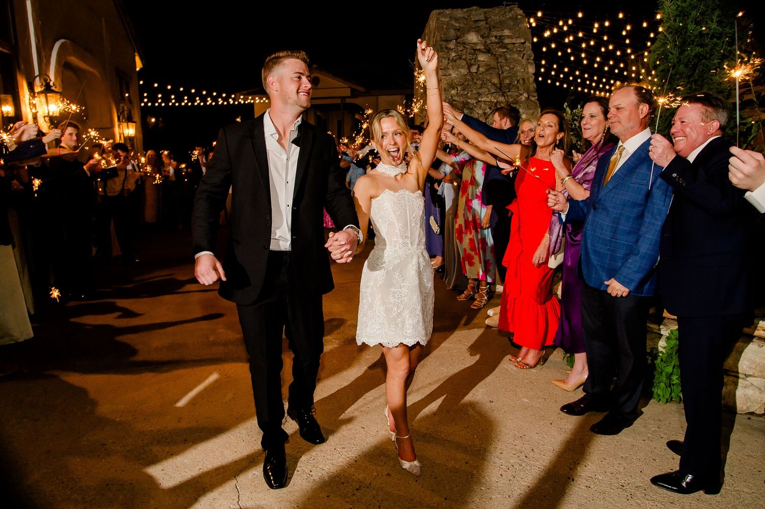 Bride and groom depart their wedding reception at Villa Antonia through fireworks at their grand exit.