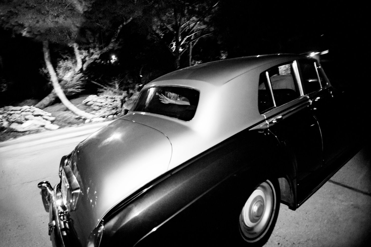 Grand exit of bride and groom in a vintage Rolls Royce at Villa Antonia