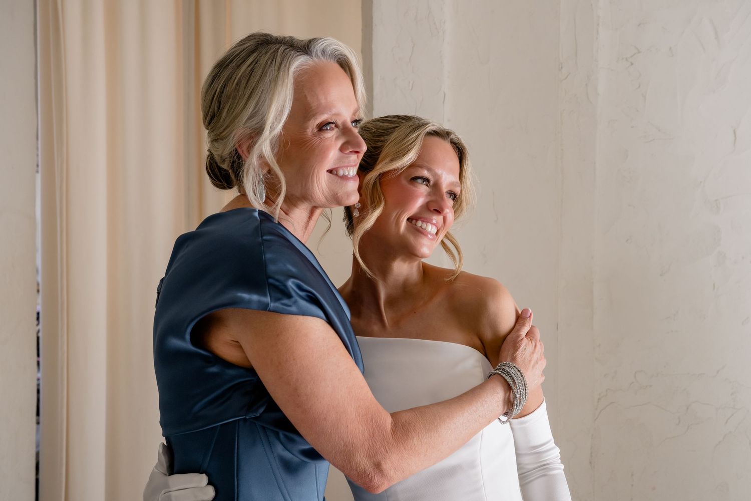 A joyful wedding moment captured as a couple embraces and laughs together during their special day at Villa Antonia