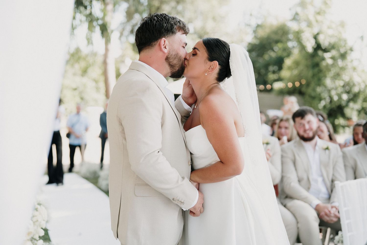 The newlyweds kiss during the civil ceremony in the park of Villa Nobel Sanremo.