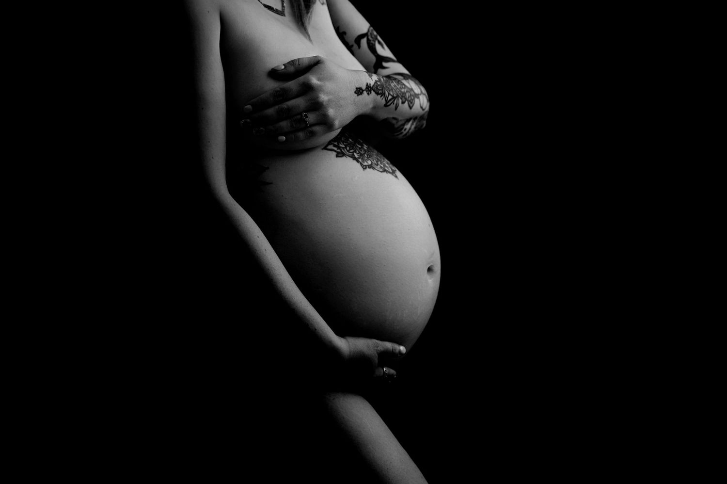 A series of artistic maternity photos showing a pregnant woman's silhouette against a dark background.