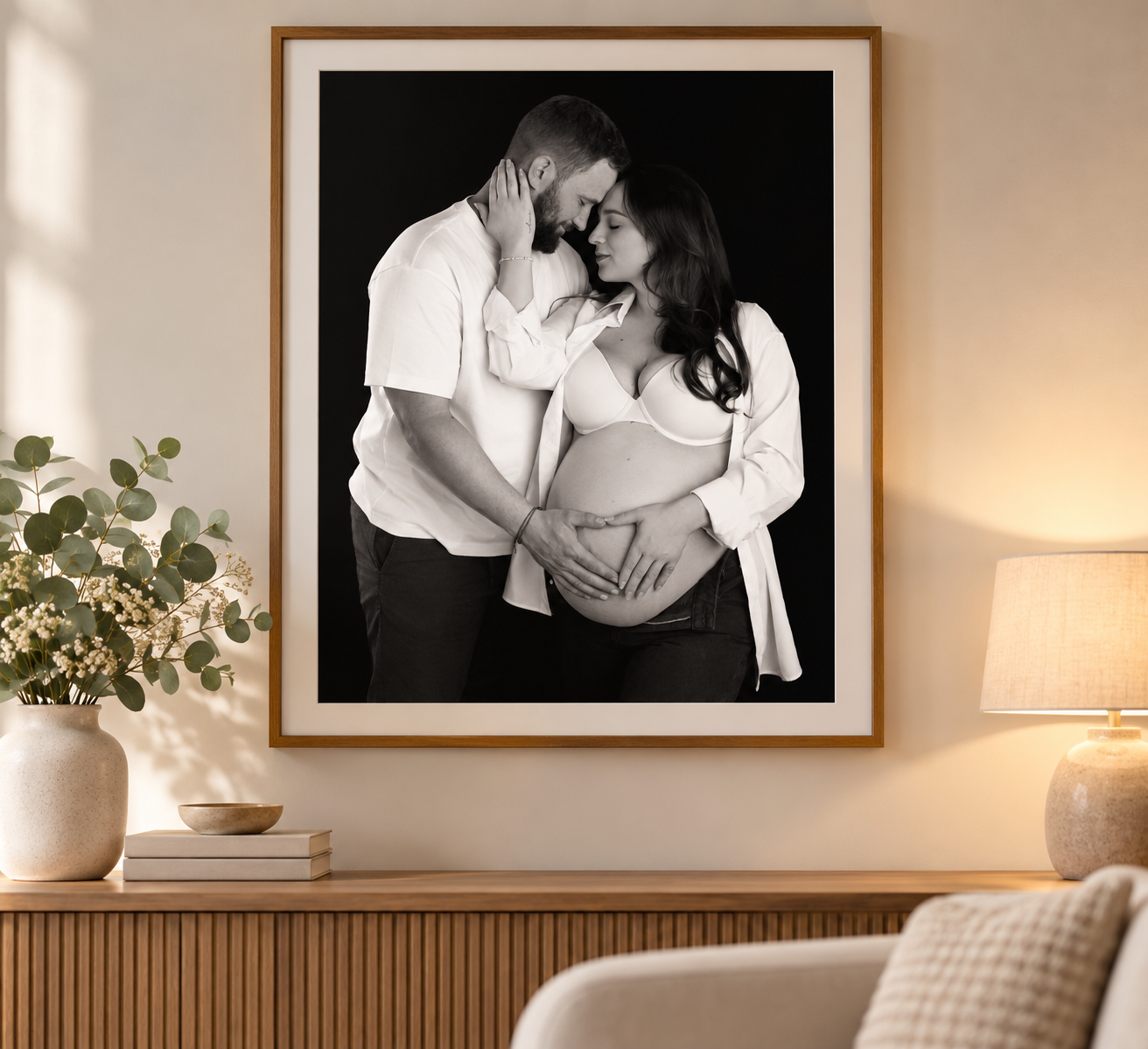 A series of artistic maternity photos showing a pregnant woman's silhouette against a dark background.