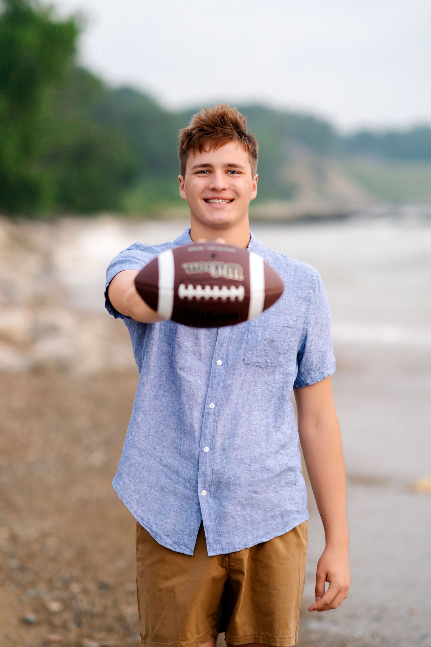 A series of photos showing someone in a blue shirt and brown pants holding a football on a beach.