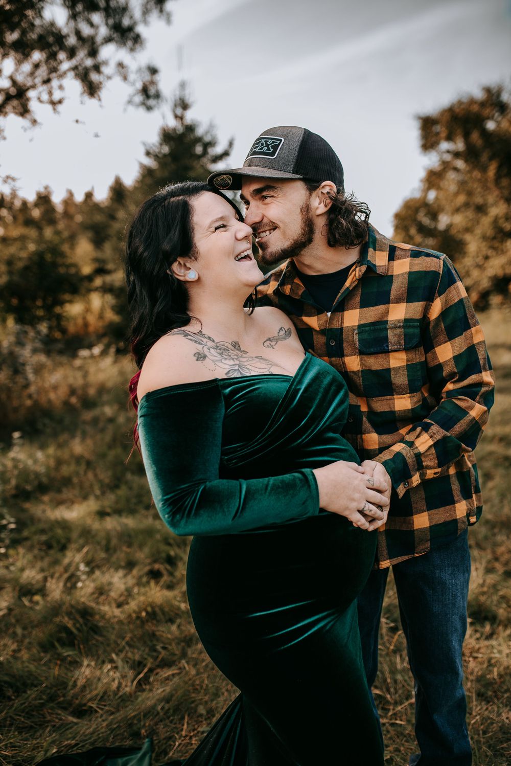A romantic couple's portrait featuring plaid and velvet attire in an autumn setting.