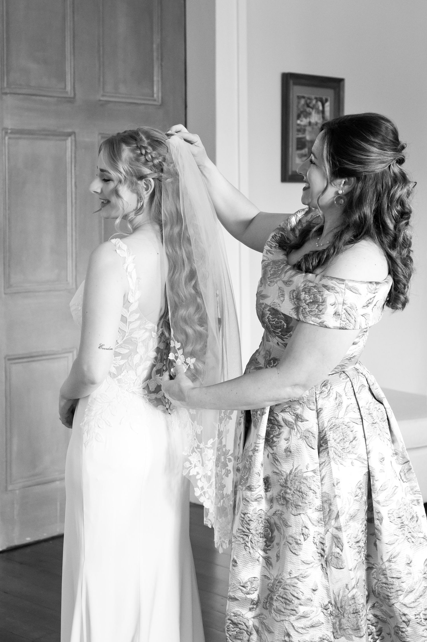 A series of black and white photos showing a bride getting ready in a vintage-style lace wedding dress.
