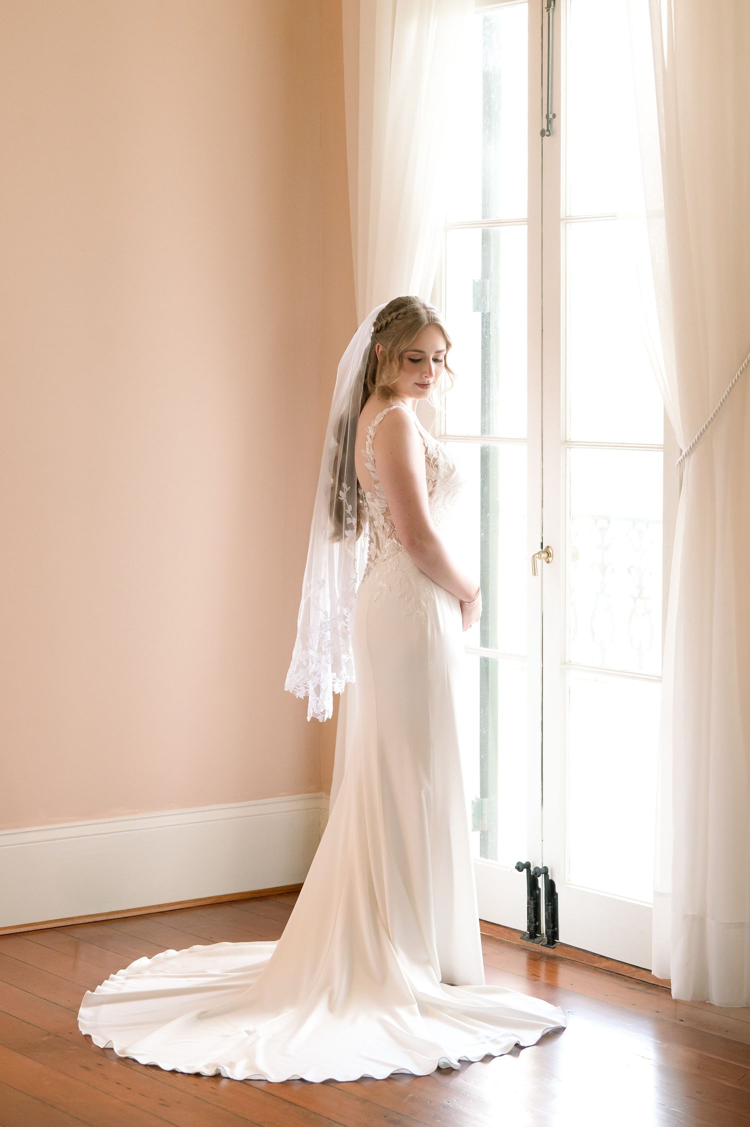 A series of bridal portraits showing an elegant wedding dress and veil in a sunlit room with hardwood floors.