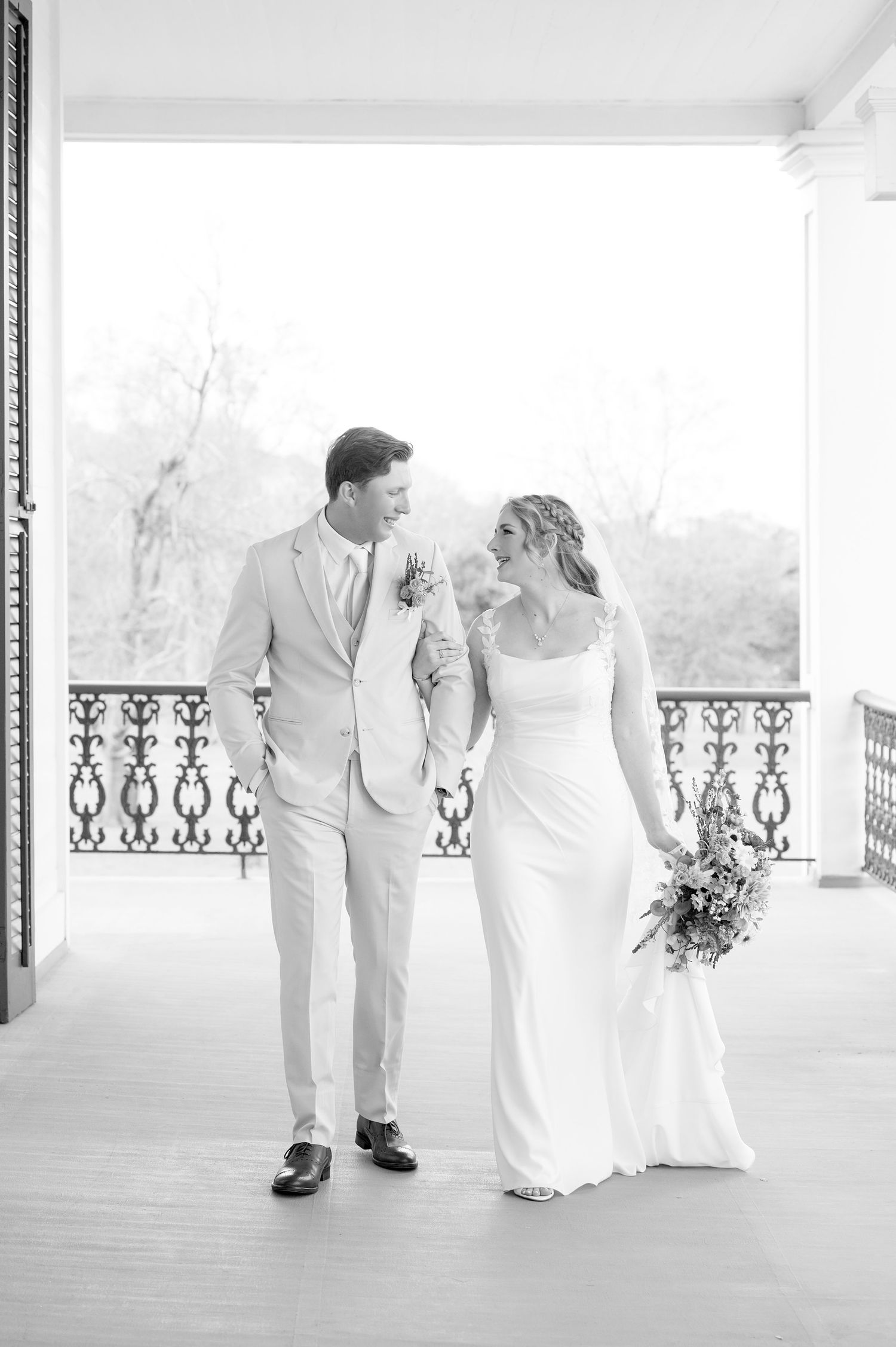A romantic black and white wedding sequence showing a couple dancing on an elegant porch with ornate railings.