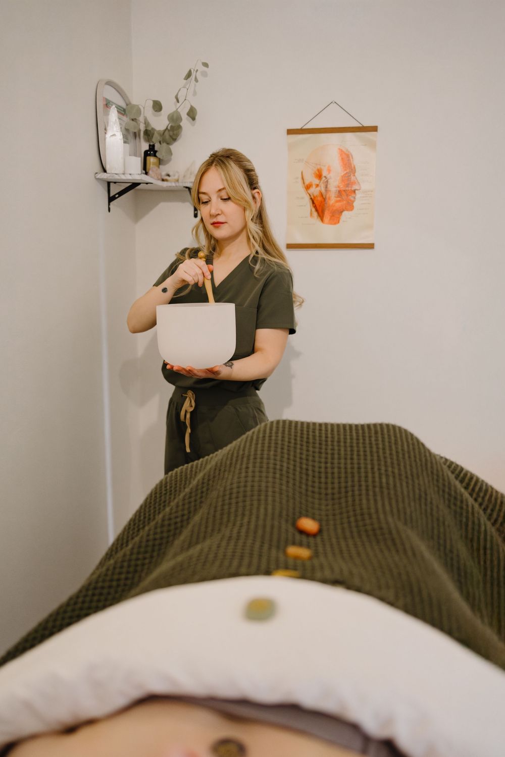 A series of photos showing someone in an olive green shirt lying on a bed with white and dark green bedding.